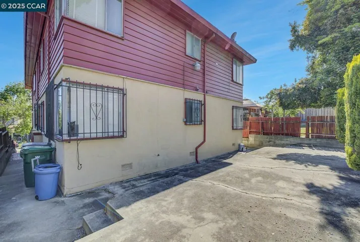 Large patio yard with gate to land area. ADU potential, garden.