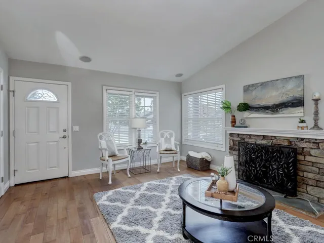 Open family room with stacked stone fireplace