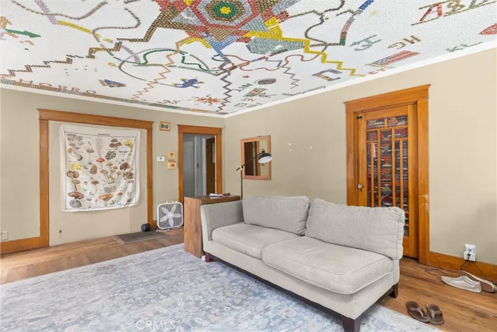 Living room with closed off entry to bedroom