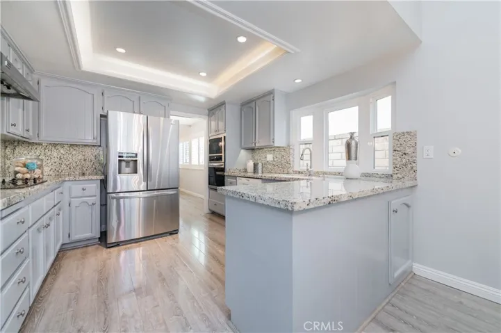 Open kitchen with breakfast bar & recessed lighting