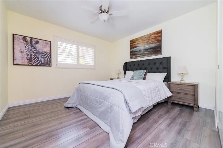 3rd bedroom with ceiling fan & custom shutters