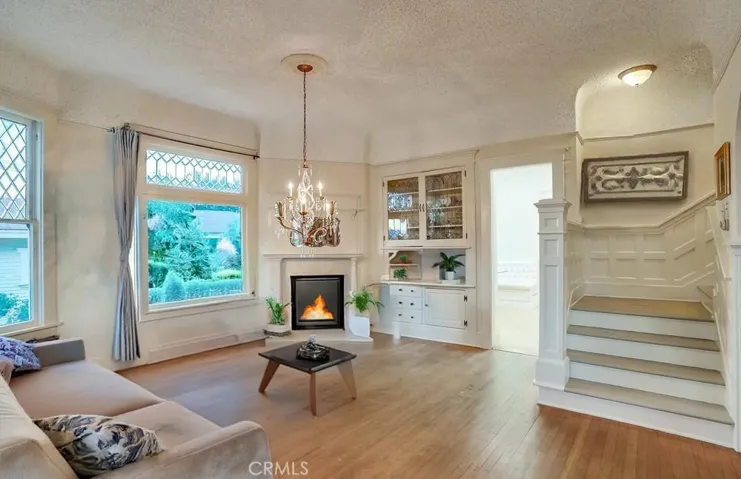 virtually staged front parlor room with fireplace