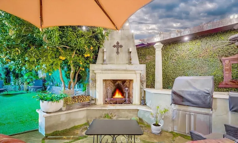 built in fireplace in beautiful backyard