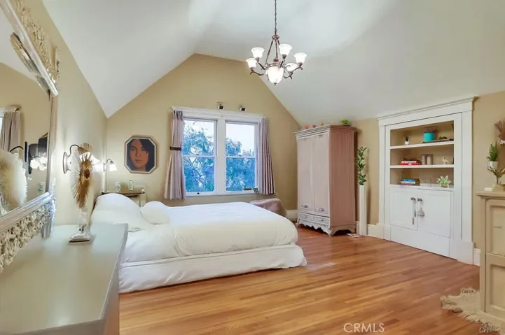 virtually staged primary room, with hidden storage behind bookcase