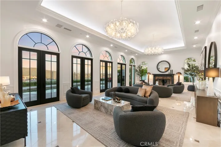 Formal Living Room at Twilight with views to the pool. Curated paint colors, light fixtures and furniture placement that create unique individuality and greatness.