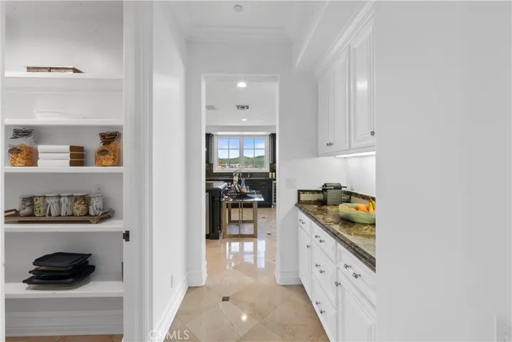 Walk-in pantry, butlers pantry with connection to formal litchen and dining room.