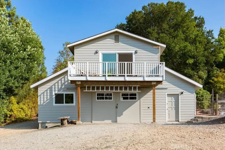 The double doors open to the workshop, the door to the right leads to the apartment entry and stairs to the main level