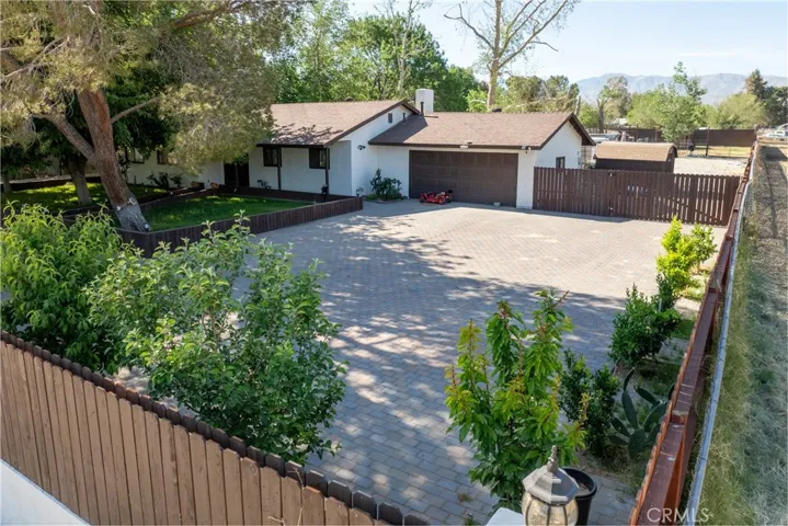 Massive fully fenced with nice paver front yard.