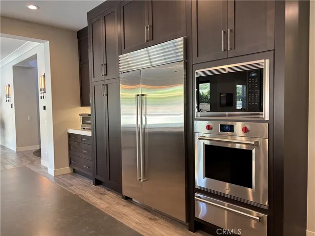 TWo fridges by Sub Zero and 3 ovens & a warming drawer by Wolf.