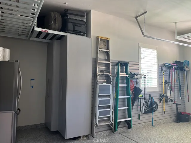 Slat wall hanging system in garage & storage rack.