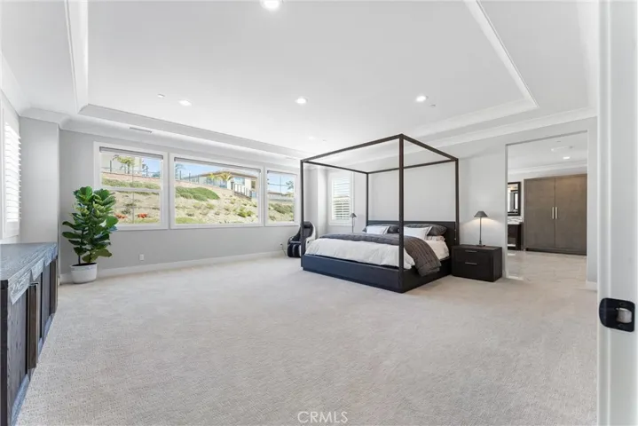Primary suite with electric blinds.