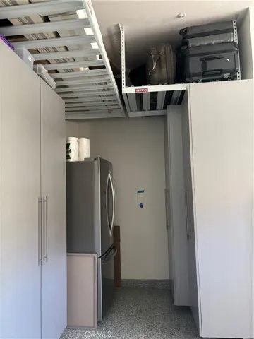 Extra large garage with room for another fridge.