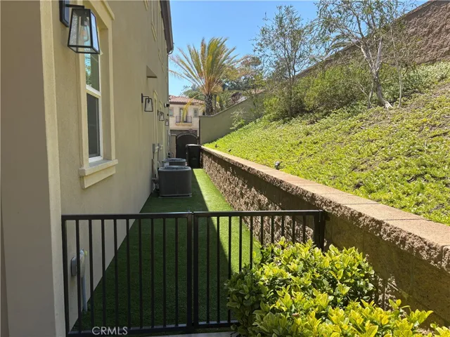Side slope-great for fruit trees & a gated dog run with artificial turf.