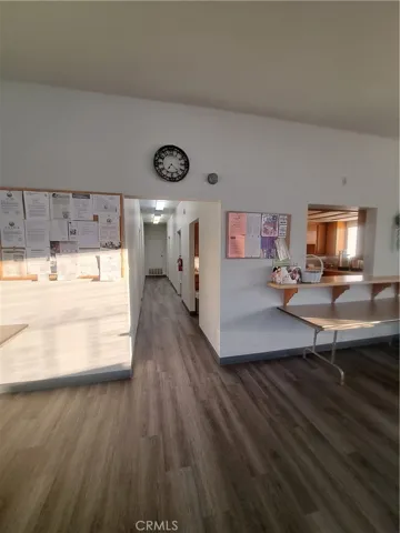 clubhouse hallway with two bathrooms, laundry room, and pool room.