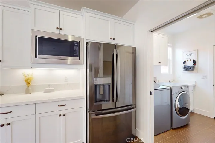A pocket door allows you to easily separate the laundry room from the kitchen.