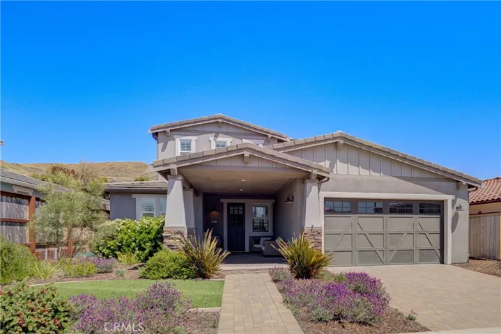 View from front curb showing the welcoming walkway and large brick-paved driveway.