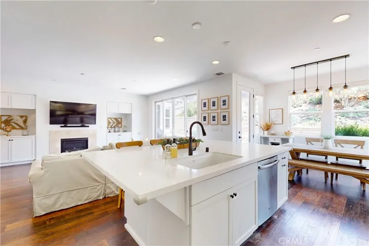 The kitchen sink is conveniently located in the island and overlooks the living room and high-top seating—perfect for entertaining and everyday living.