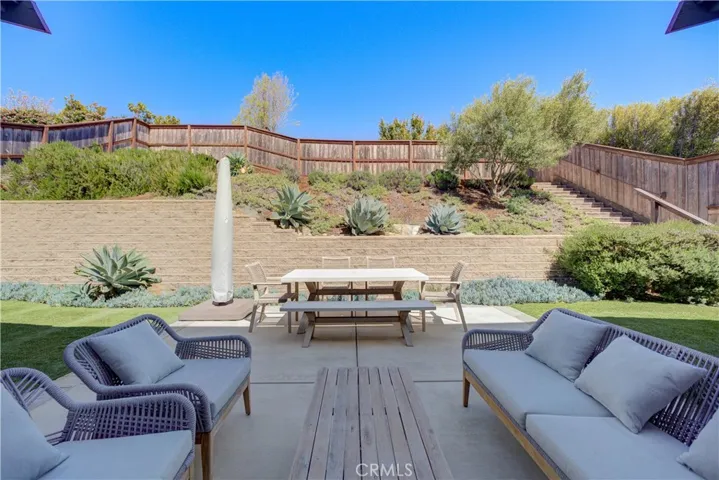 The backyard features an open-air patio with grass on both sides - perfect for relaxing or entertaining.