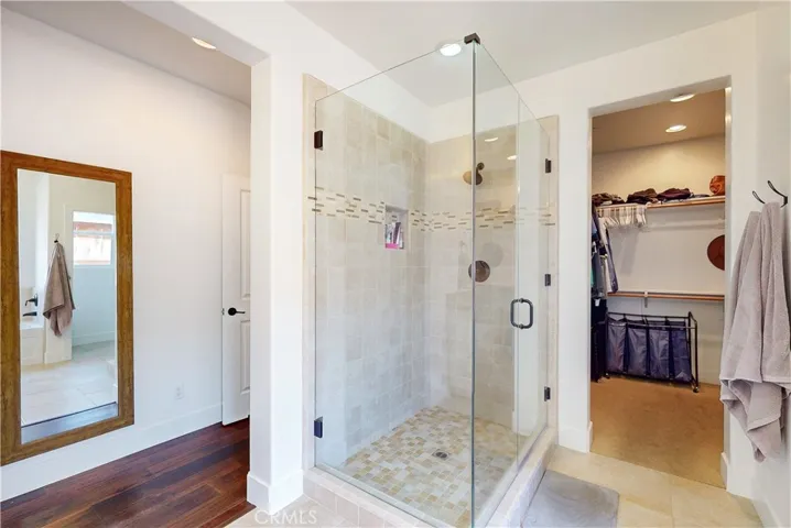 Glass-enclosed walk-in shower in the primary bathroom.