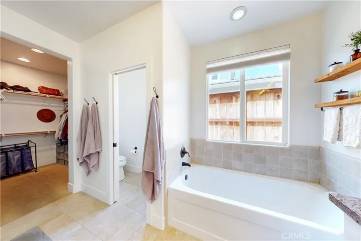 Primary bathroom features a soaking tub and private water closet.