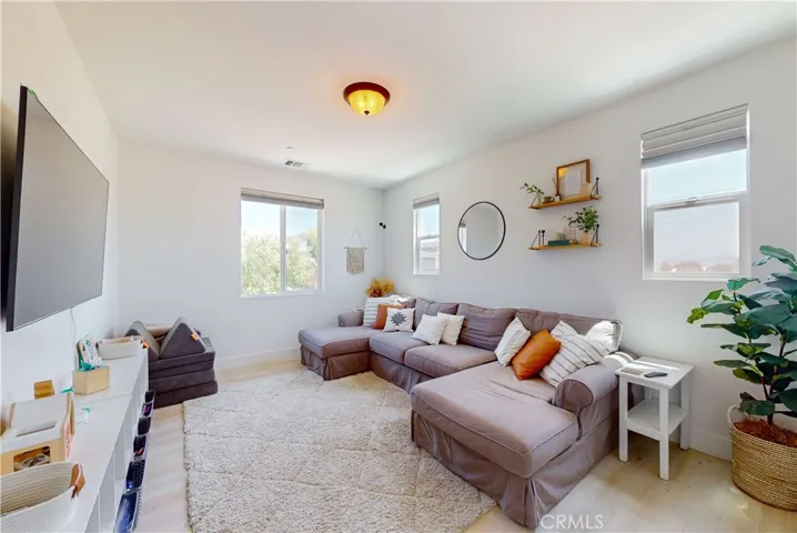 Upstairs Bedroom 1—currently used as a living space—is spacious and filled with natural light.