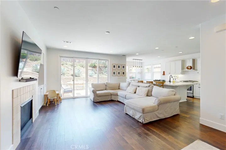 Living room with large sliding glass door accessing the backyard.
