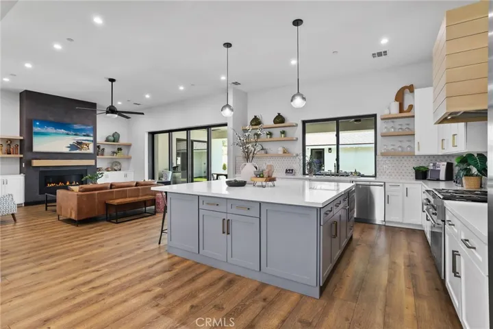 Open-Concept Sophistication – Modern pendant lights and an airy layout create the perfect gathering space for family and friends.