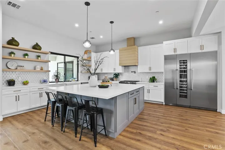 Entertainer’s Kitchen – Perfect for hosting, this kitchen features a breakfast bar, open shelving, and expansive prep space.