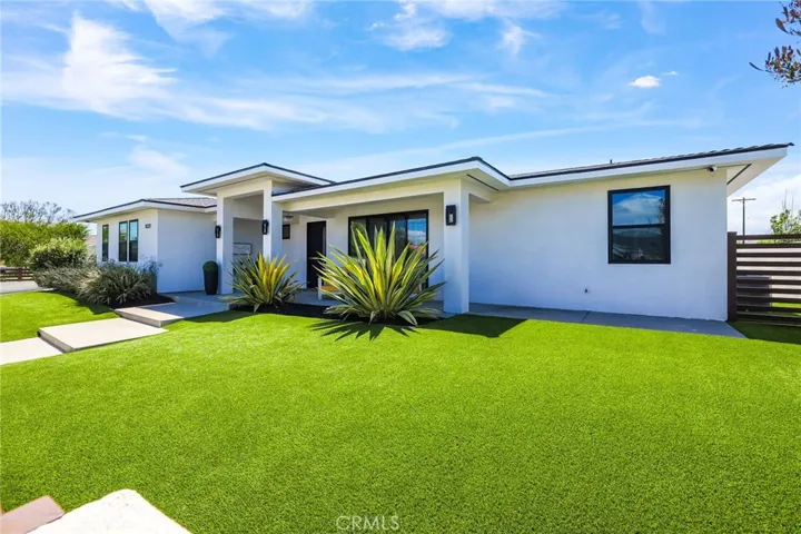 Modern Curb Appeal – Sleek lines, lush green lawn, and impeccable landscaping welcome you to this stunning single-story home.