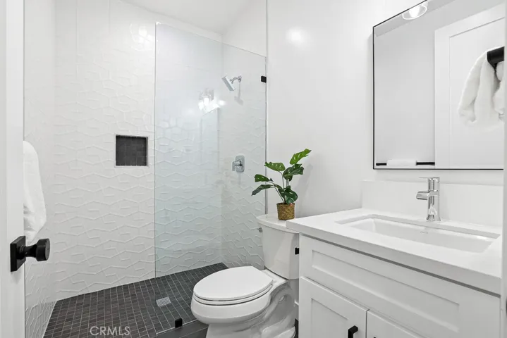 Luxurious walk-in shower with frameless glass, polished tile, and a floating vanity—this bathroom offers spa-like relaxation every day.