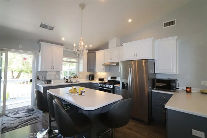 Island with casual dining. Note under cabinet lighting.