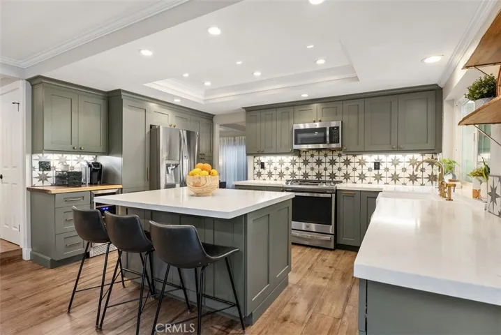 Beautiful newly remodeled kitchen with custom cabinetry, stainless steel appliances & quartz counter tops.