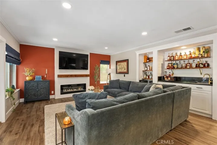 Family room with fireplace and wet bar area.