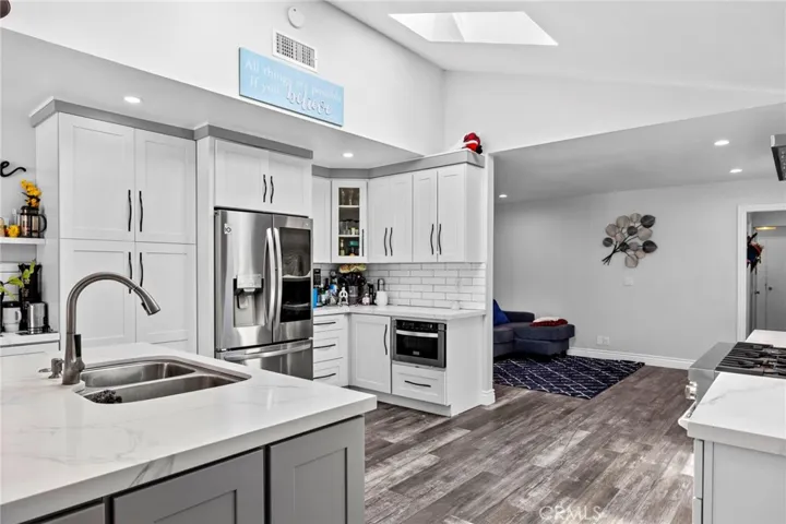 White quartz countertops, Grey Accents, White Casbinets, Z LINE Michrowave