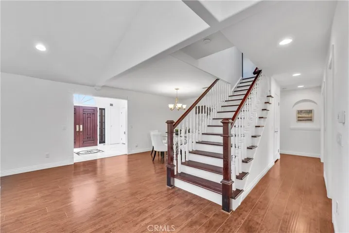 handcrafted wood staircase takes center stage, carefully positioned for optimal feng shui