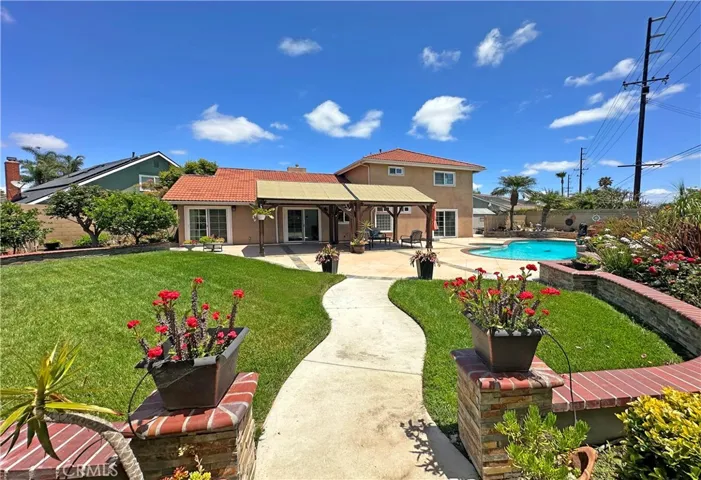 show-stopping park-like backyard oasis that rivals a lavish wedding venue, complete with lush lawn, vibrant gardens, sparkling pool & spa, tranquil fountain, raised brick planters, enchanting gazebo, and large covered patio perfect for entertaining & outdoor dining