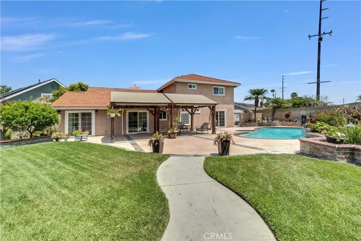 Show-stopping park-like backyard oasis that rivals a lavish wedding venue, complete with lush lawn, vibrant gardens, sparkling pool & spa, tranquil fountain, raised brick planters, enchanting gazebo, and large covered patio perfect for entertaining & outdoor dining