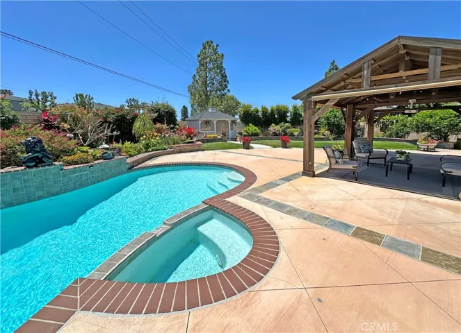 Resort Backyard with Sparkling Pool, Spa, Covered Patio, Huge Lawn, Flowering Gardens, & Gazebo