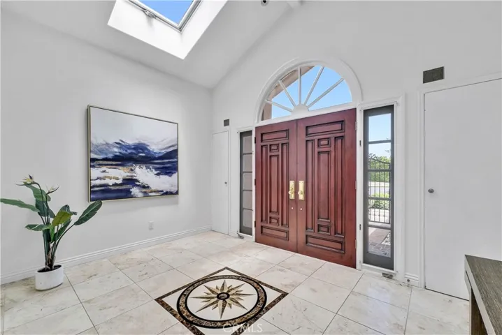 Dramatic Marble Foyer with Inlay and Soaring Ceiling with Skylights

