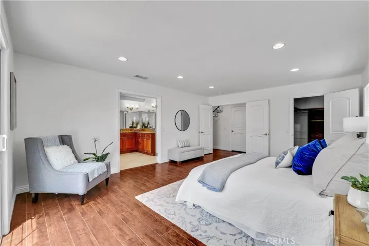 The primary suite is a sanctuary of relaxation with an organized walk-in closet & spa-style bathroom featuring a dual-sink vanity w/sit-down area, jetted soaking tub, and a separate shower
