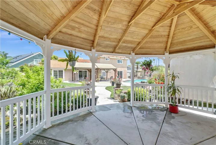 Show-stopping park-like backyard oasis that rivals a lavish wedding venue, complete with lush lawn, vibrant gardens, sparkling pool & spa, tranquil fountain, raised brick planters, enchanting gazebo, and large covered patio perfect for entertaining & outdoor dining