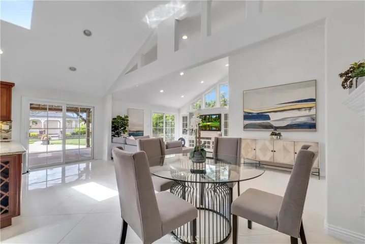Breakfast area and enormous family room w/custom built-in entertainment center and French doors to the breathtaking backyard