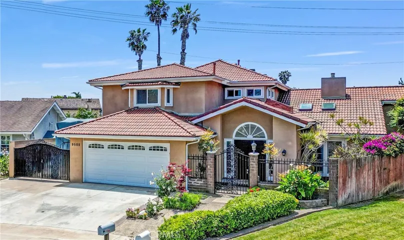Beautiful Curb Appeal with Manicured Landscaping, Custom Hardscape, and Spanish Tile Roof