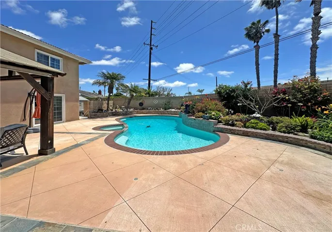 show-stopping park-like backyard oasis that rivals a lavish wedding venue, complete with lush lawn, vibrant gardens, sparkling pool & spa, tranquil fountain, raised brick planters, enchanting gazebo, and large covered patio perfect for entertaining & outdoor dining