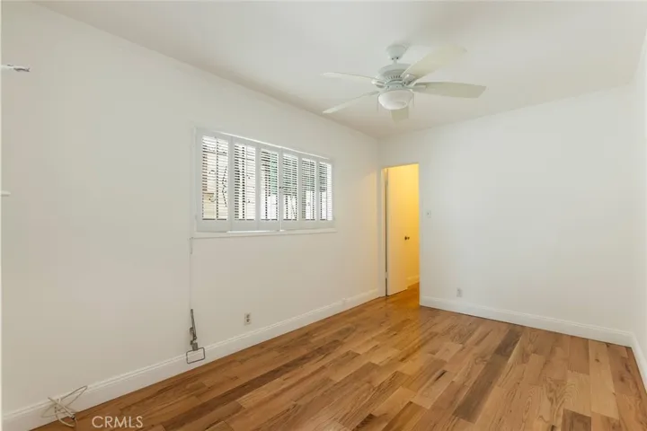 2nd bedroom with nice shuttered windows and hardwood floors