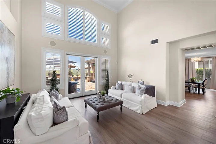 Living room with high ceilings and opens to outside