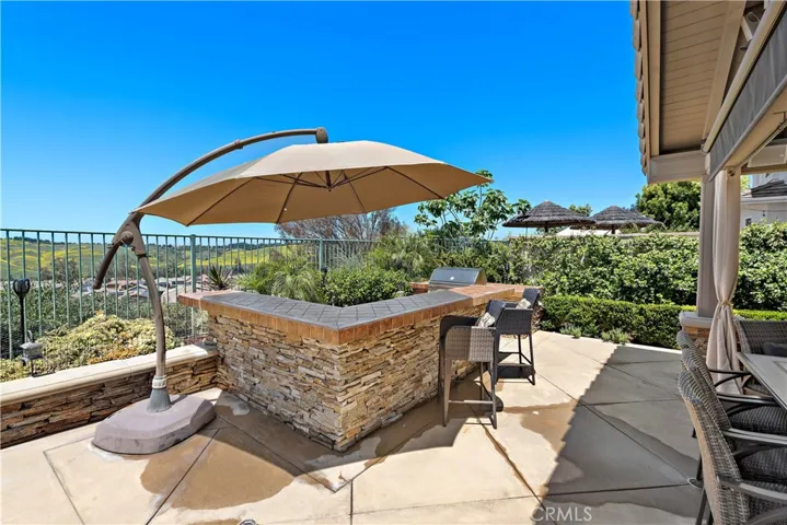 outdoor bar with bar b q and refridgerator