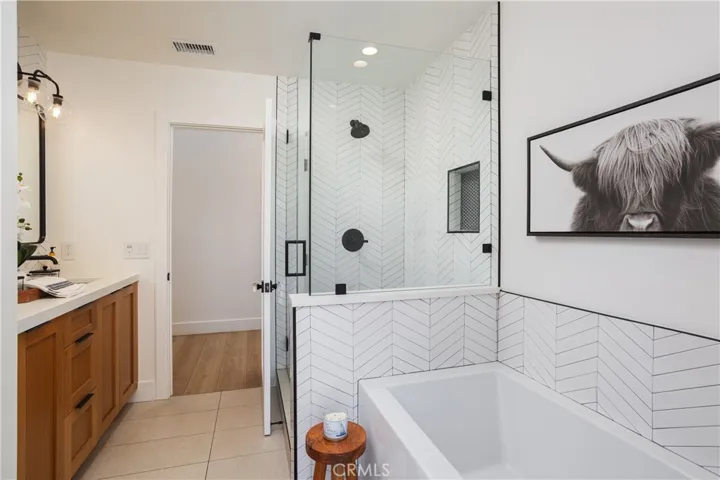 secondary bathroom with separate tub and shower