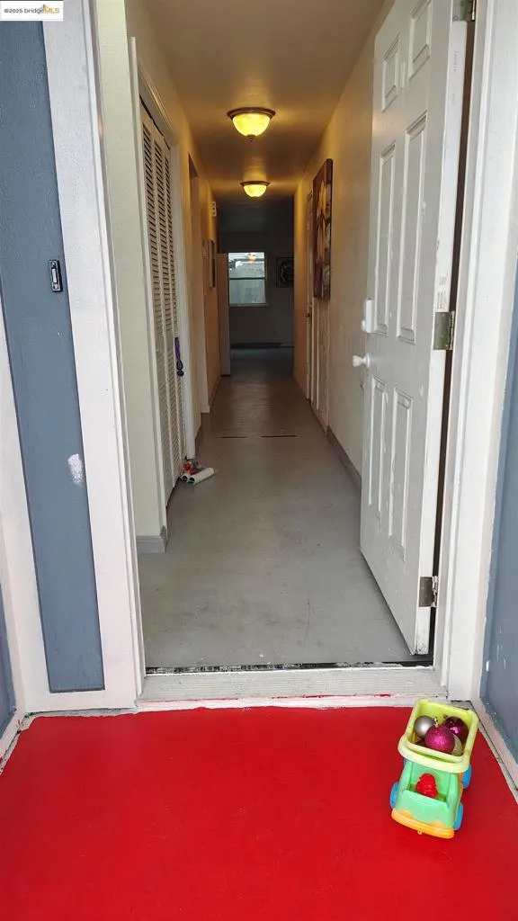 Corridor featuring finished concrete floors