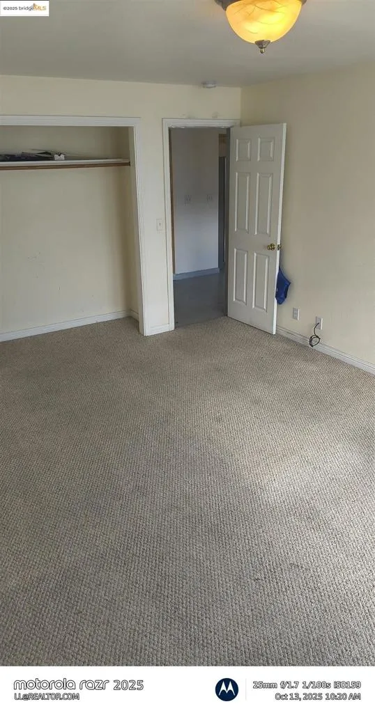 Unfurnished bedroom featuring carpet and baseboards